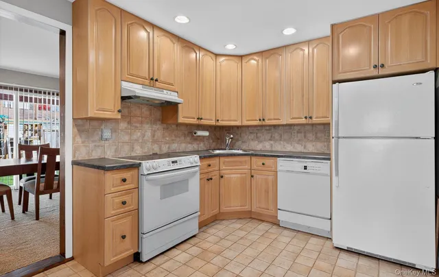 a kitchen with stainless steel appliances granite countertop a refrigerator sink and cabinets