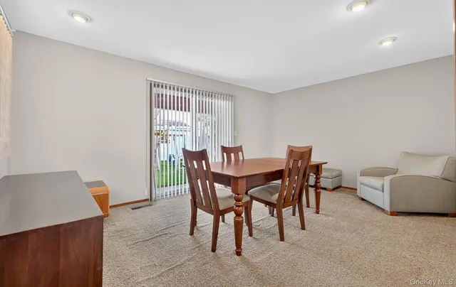 a view of a dining room with furniture and window