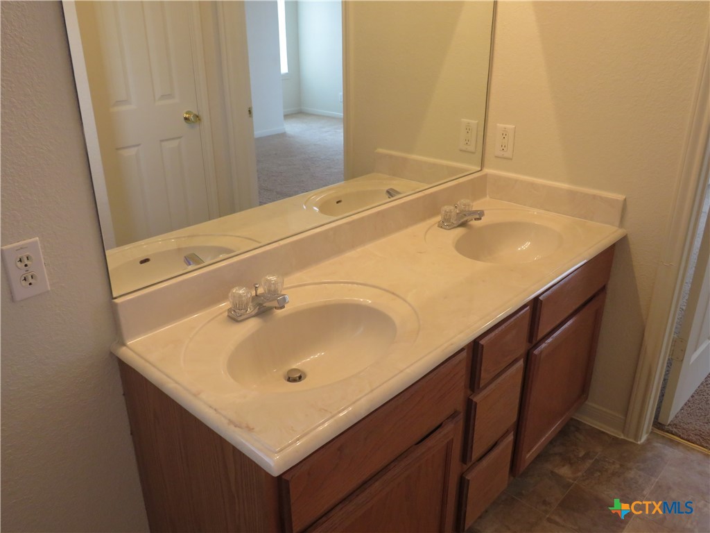 5804 Hamza Circle Killeen, TX 76542 - Photo 14 of 18 a bathroom with a sink and a mirror