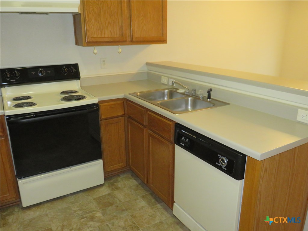5804 Hamza Circle Killeen, TX 76542 - Photo 7 of 18 a kitchen with a sink and a stove top oven
