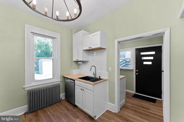 a kitchen that has a lot of cabinets furniture and a window
