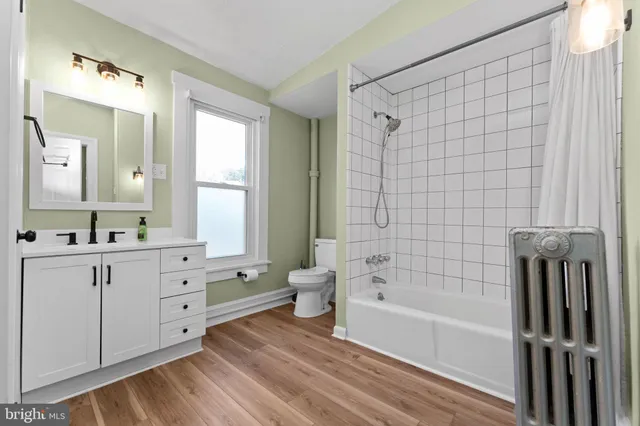 a bathroom with a bathtub shower sink and toilet