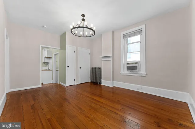a view of a room with wooden floor and window