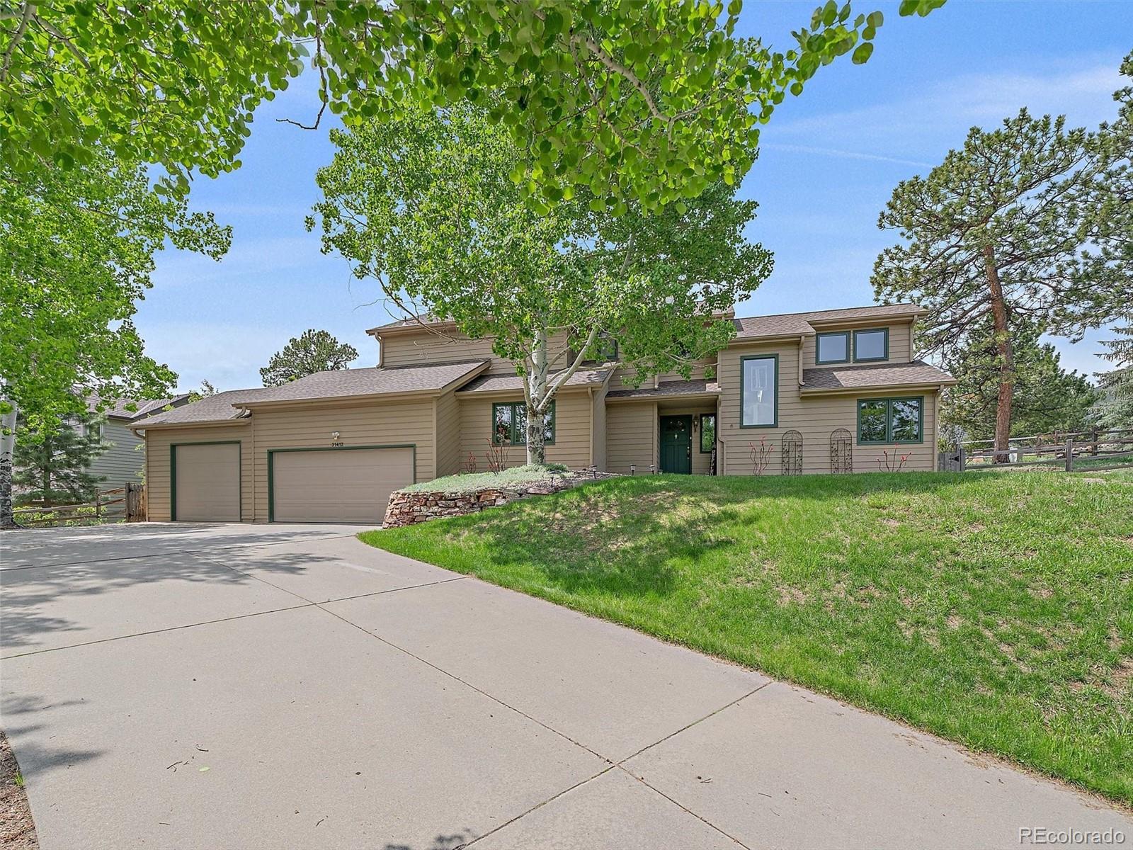 a front view of a house with a yard and a garage