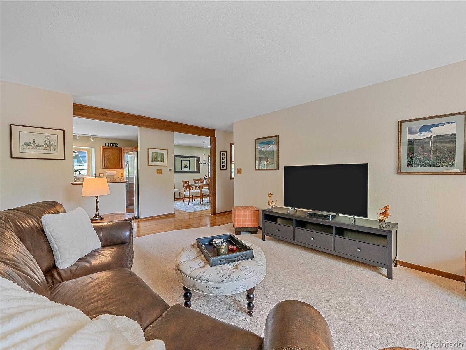 31412 North Bermuda Dunes Drive Evergreen, CO 80439 - Photo 12 of 46 a living room with furniture and a flat screen tv