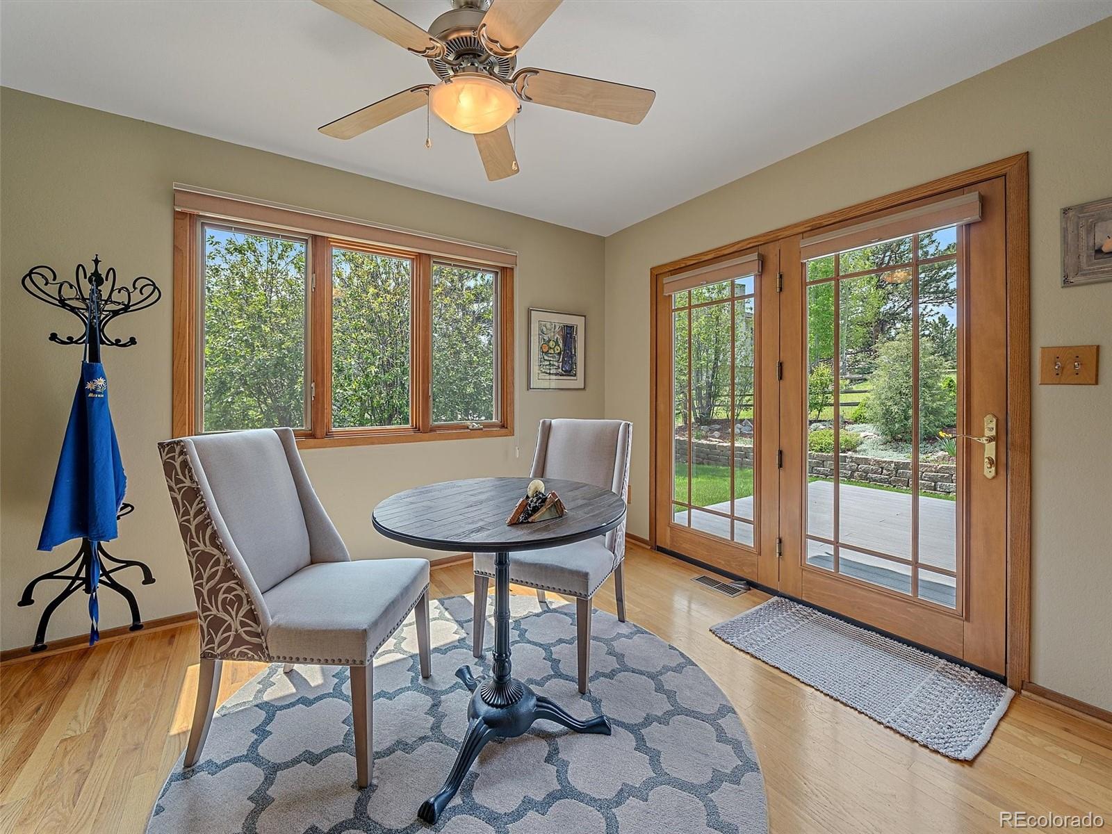 31412 North Bermuda Dunes Drive Evergreen, CO 80439 - Photo 16 of 46 a view of a room with furniture wooden floor and a chandelier