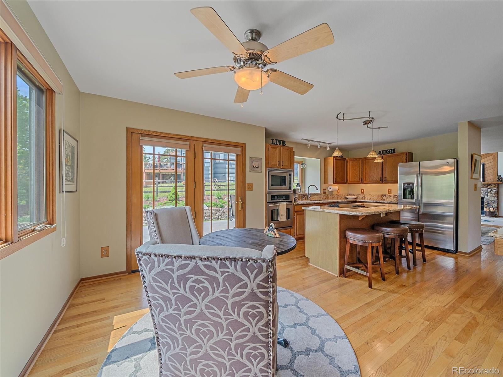 31412 North Bermuda Dunes Drive Evergreen, CO 80439 - Photo 17 of 46 a view of a dining room with furniture window and wooden floor