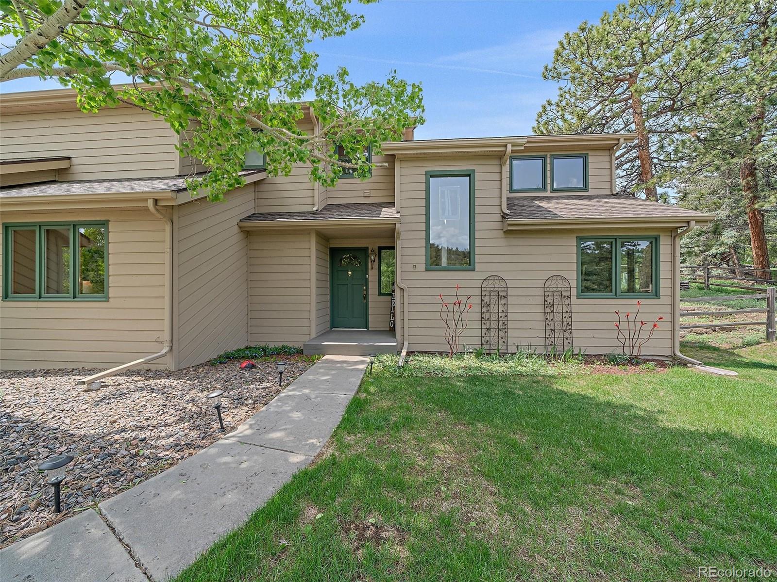 31412 North Bermuda Dunes Drive Evergreen, CO 80439 - Photo 2 of 46 front view of a house with a yard