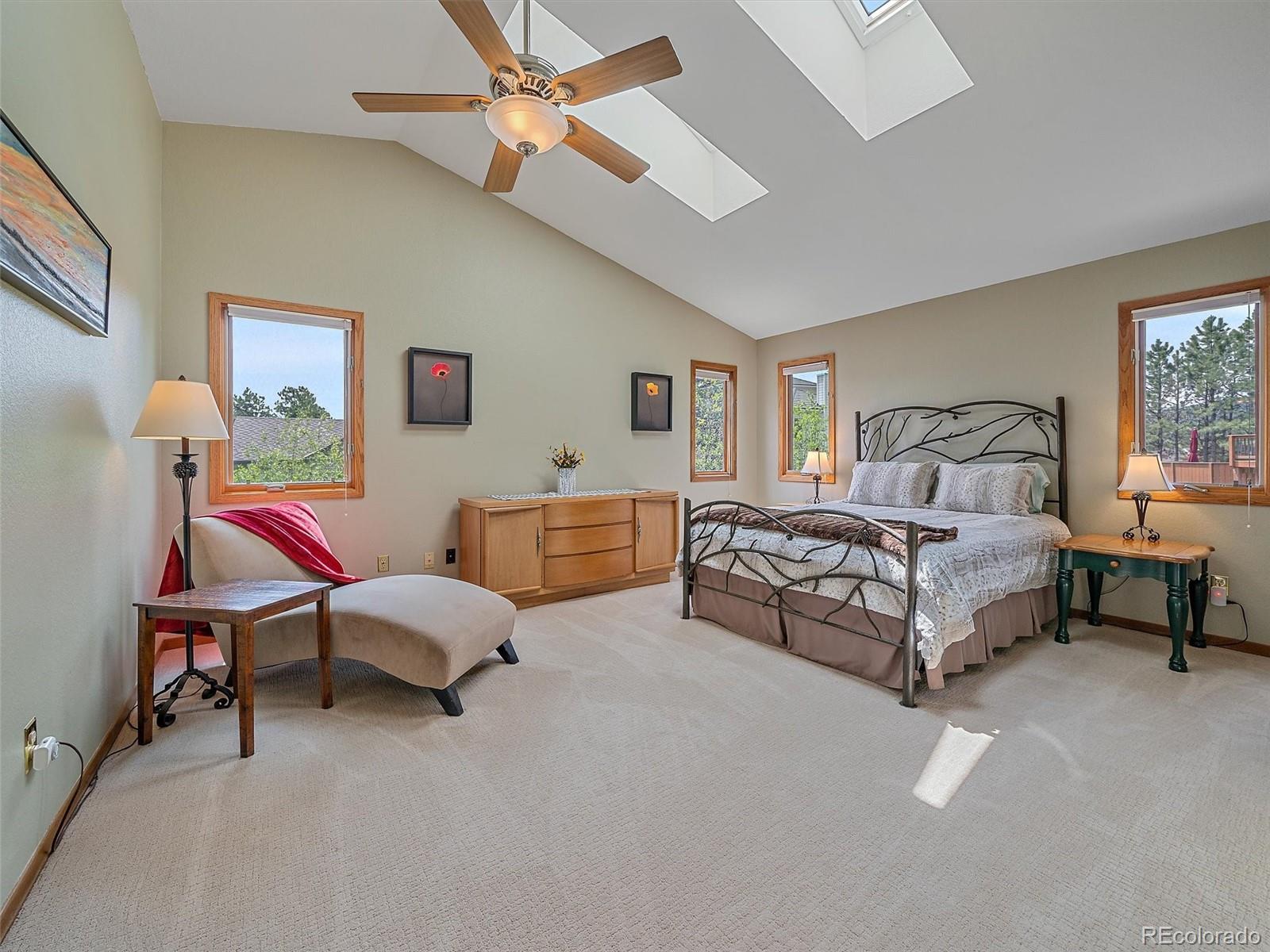 31412 North Bermuda Dunes Drive Evergreen, CO 80439 - Photo 24 of 46 a spacious bedroom with a bed and a couch