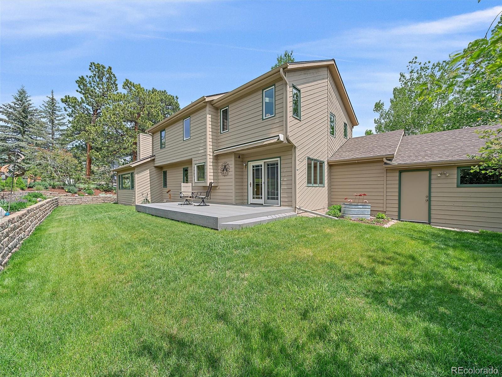 31412 North Bermuda Dunes Drive Evergreen, CO 80439 - Photo 3 of 46 a front view of a house with a yard