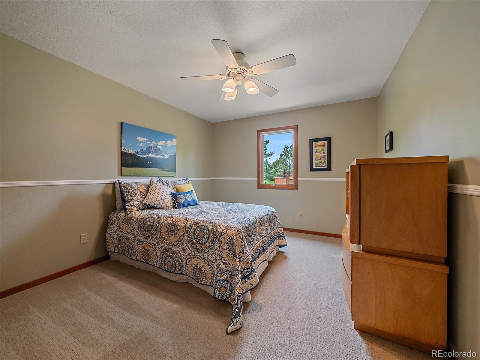 31412 North Bermuda Dunes Drive Evergreen, CO 80439 - Photo 31 of 46 a bedroom with a bed and a refrigerator