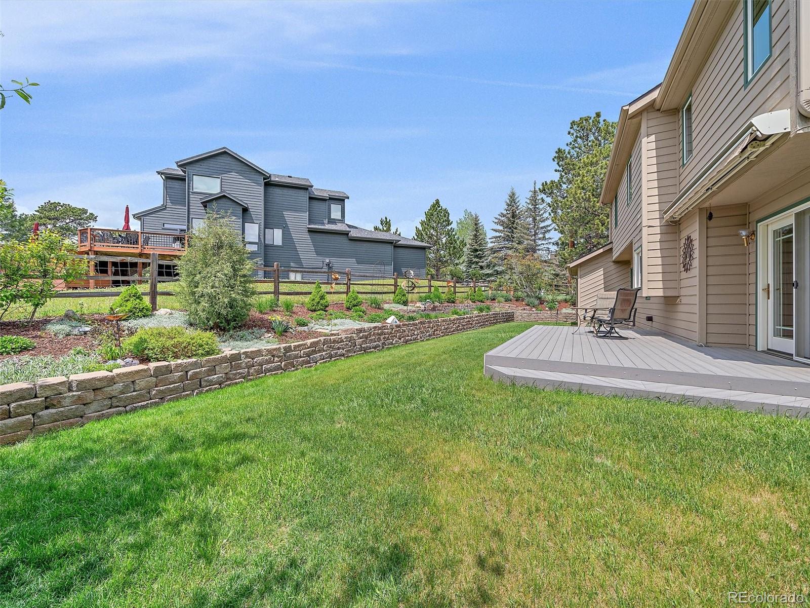 31412 North Bermuda Dunes Drive Evergreen, CO 80439 - Photo 35 of 46 a view of a house with a yard and a fountain