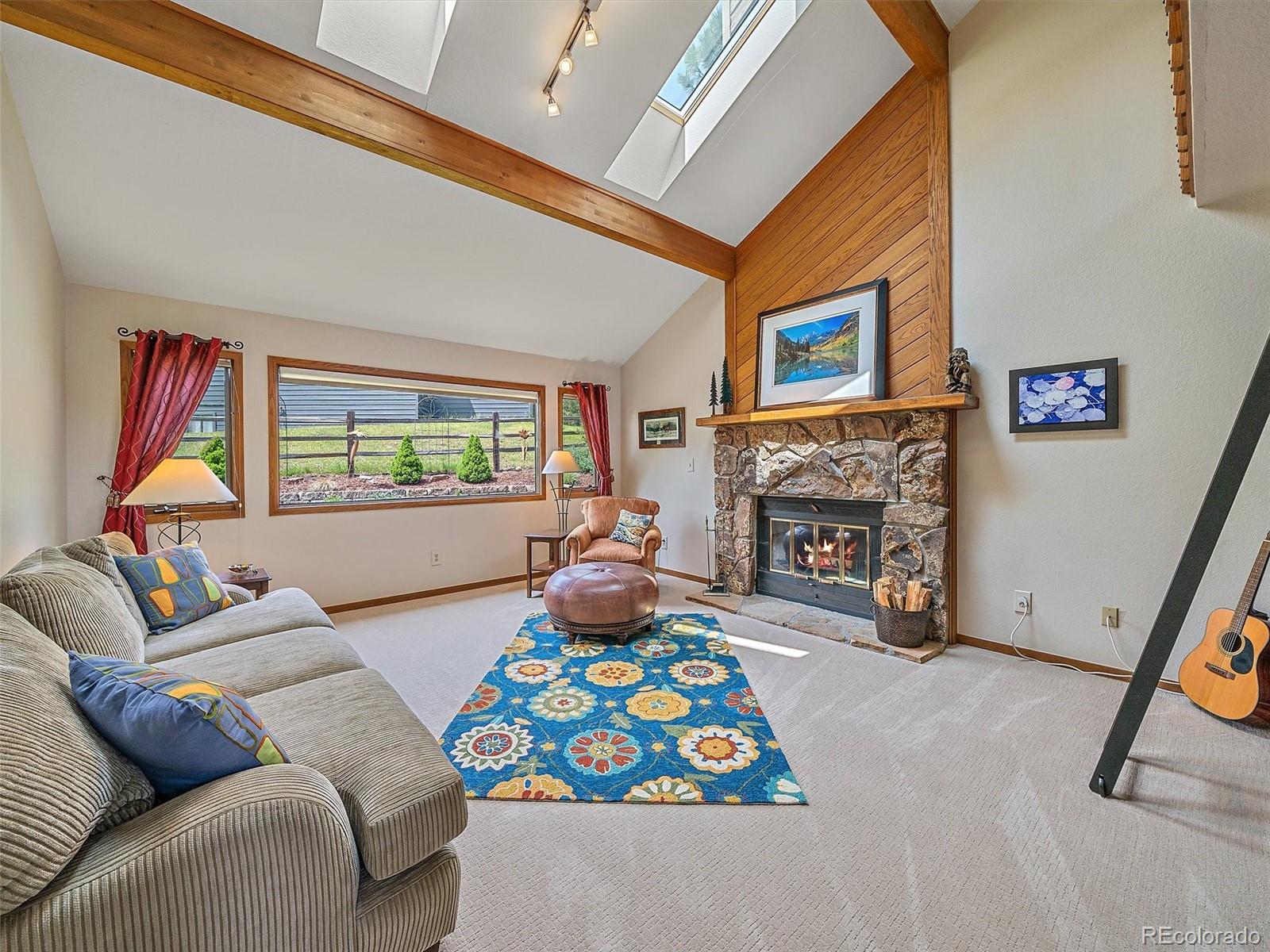 31412 North Bermuda Dunes Drive Evergreen, CO 80439 - Photo 4 of 46 a living room with furniture and a fireplace