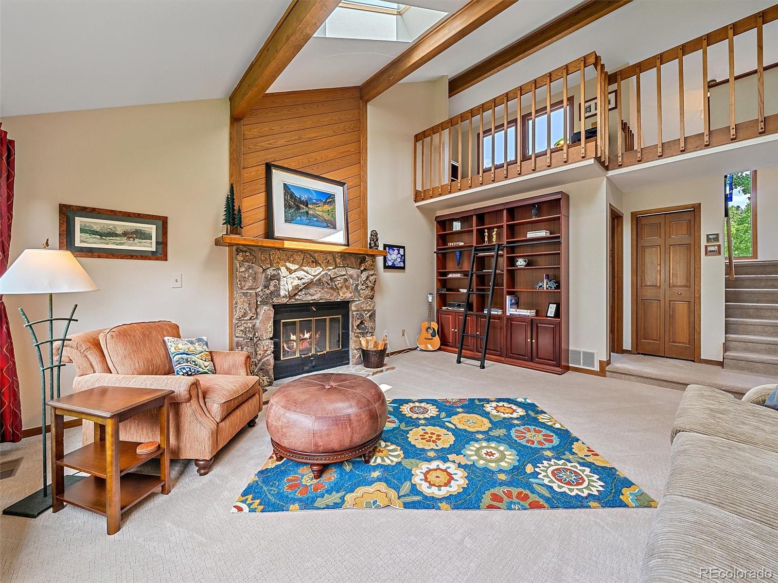 31412 North Bermuda Dunes Drive Evergreen, CO 80439 - Photo 5 of 46 a living room with furniture a fireplace and a window