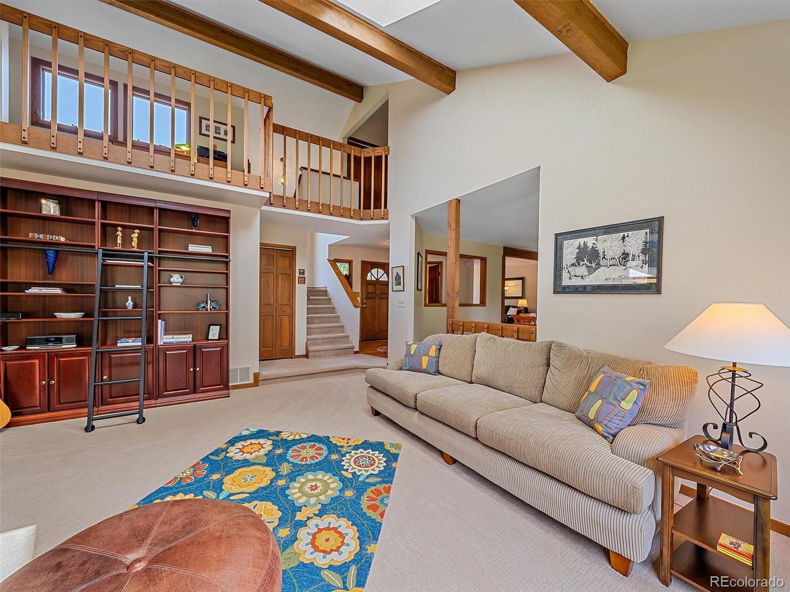 31412 North Bermuda Dunes Drive Evergreen, CO 80439 - Photo 6 of 46 a bedroom with furniture and a couch