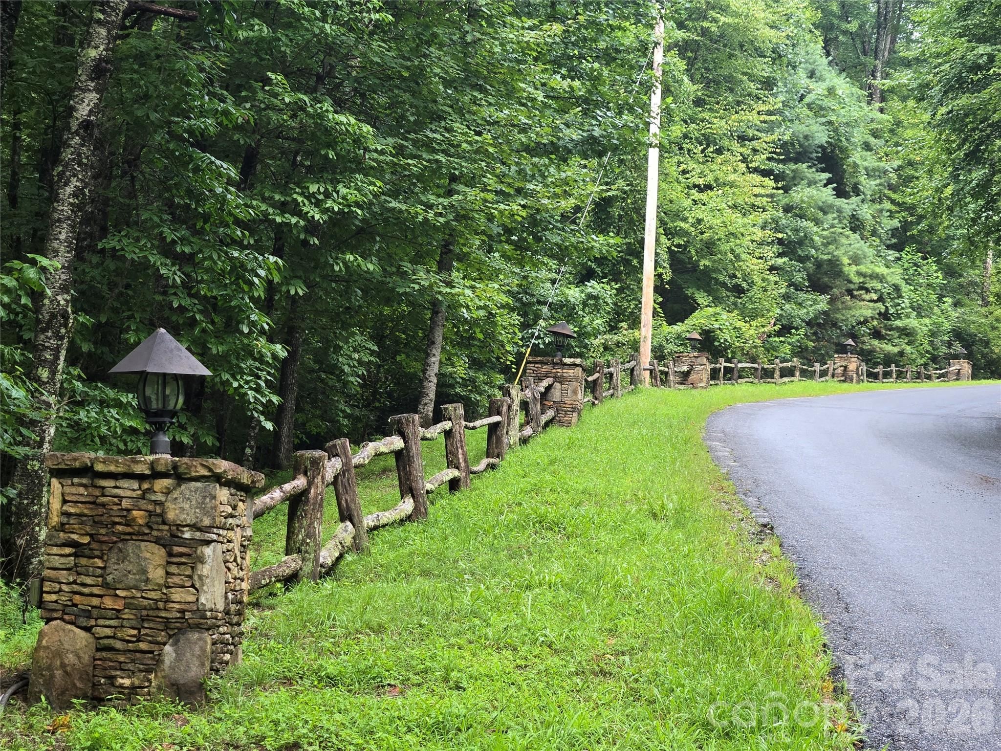 303 Ladd Ridge Road Rosman, NC 28772 - Photo 26 of 32 a view of a backyard with chairs