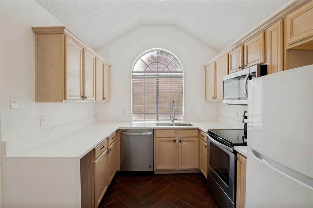 8160 Tower Road Frisco, TX 75035 - Photo 7 of 25 a kitchen with stainless steel appliances a sink stove and cabinets