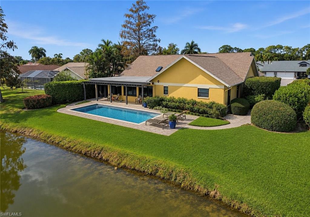 2274 Queens Way Naples, FL 34112 - Photo 28 of 28 a front view of a house with garden