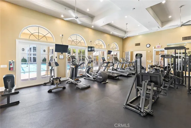 a front view of multi story residential apartment building with yard and sign board