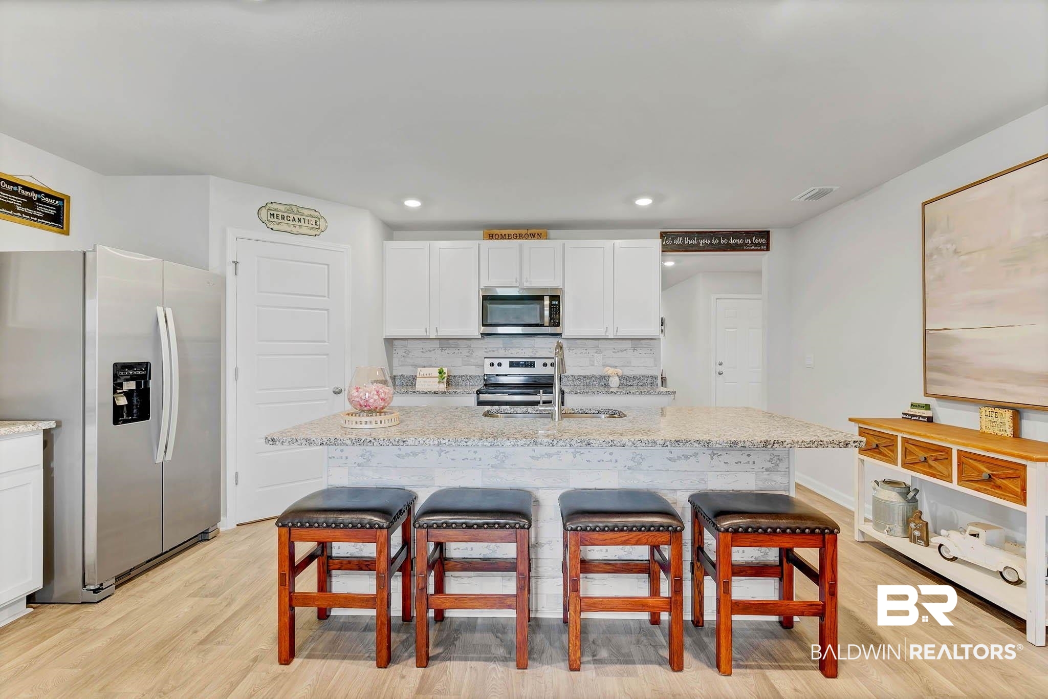 17217 REFLECTION Street Loxley, AL 36551 - Photo 11 of 83 Kitchen with stainless steel appliances, white cabinets, a breakfast bar area, light wood-style lvp flooring, granite countertops and recessed lighting