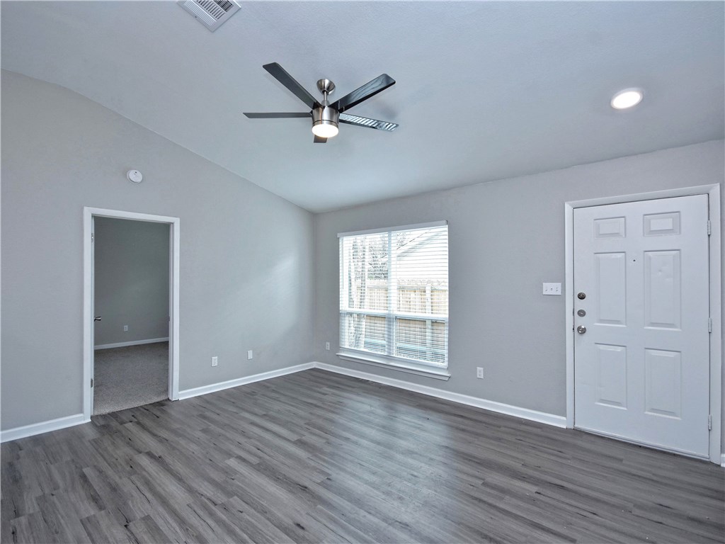 2302 Fuzz Fairway, Unit B Austin, TX 78728 - Photo 8 of 27 Living Room with high ceilings and ceiling fan.