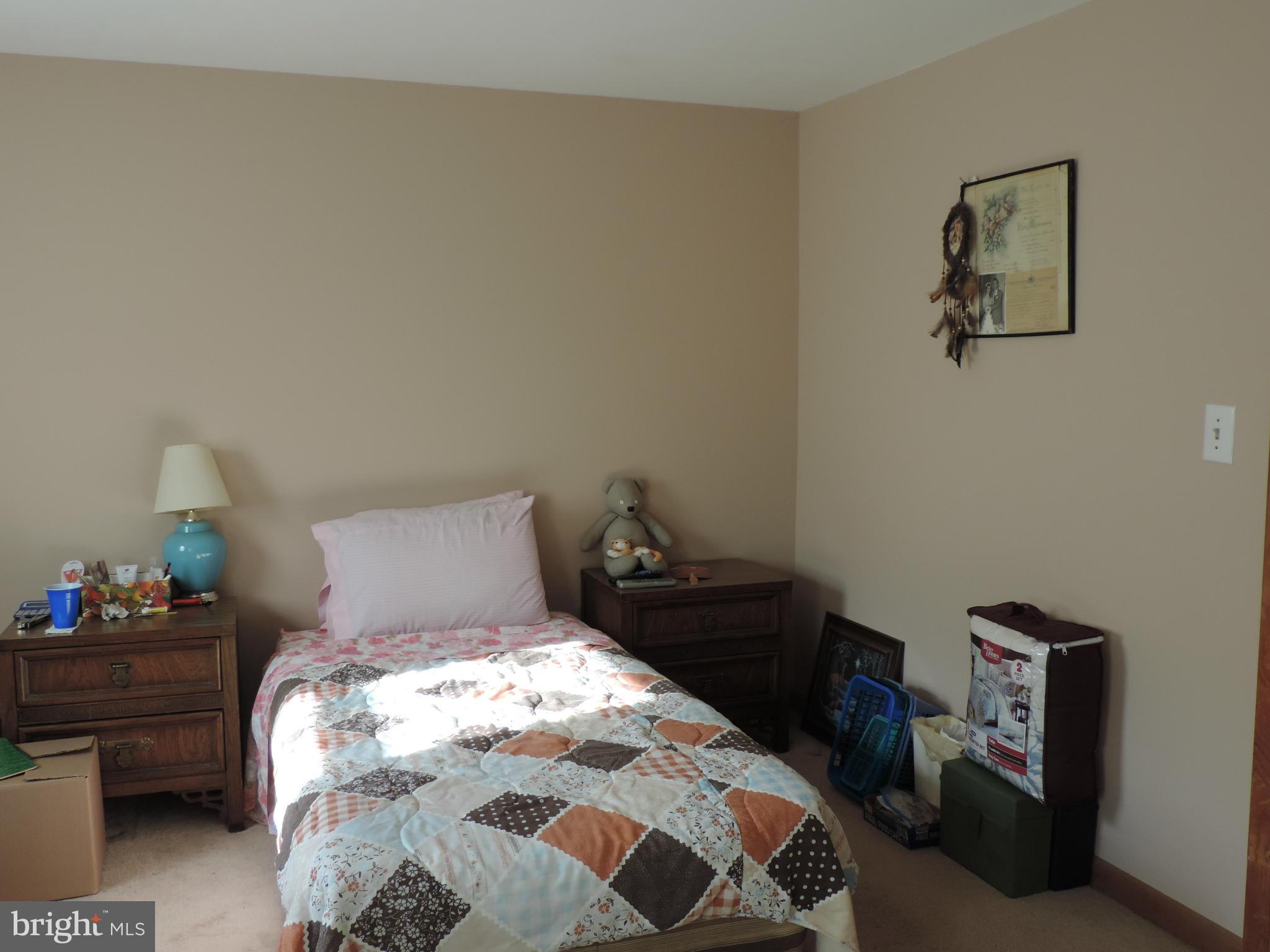 9215 Hawkins Creamery Road Gaithersburg, MD 20882 - Photo 2 of 23 a bedroom with a bed and wooden floor