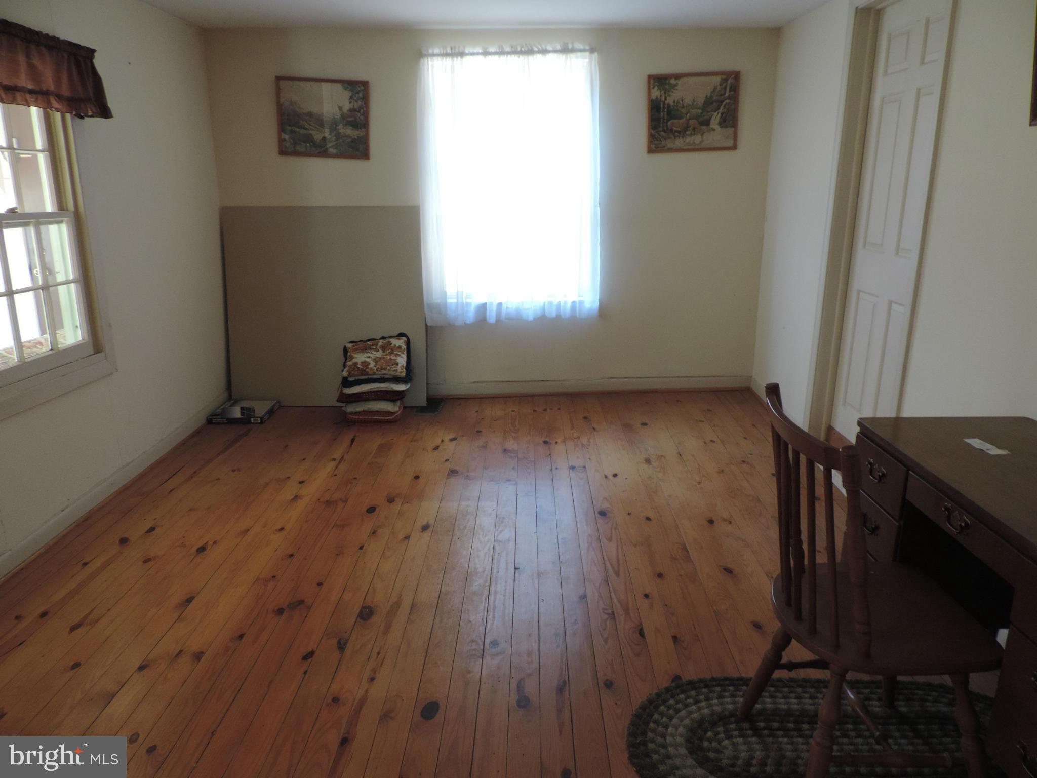 9215 Hawkins Creamery Road Gaithersburg, MD 20882 - Photo 11 of 23 an empty room with wooden floor and windows