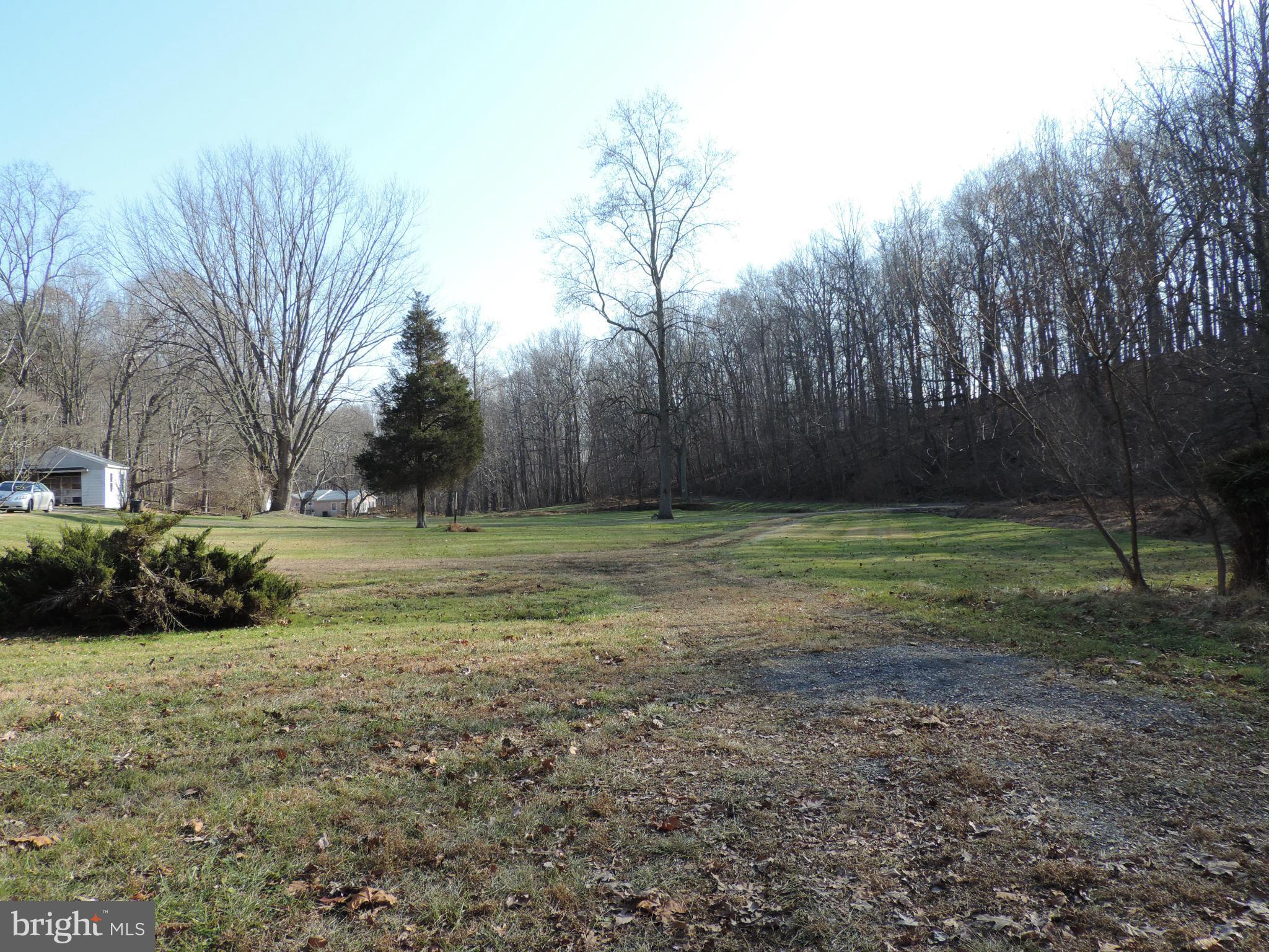 9215 Hawkins Creamery Road Gaithersburg, MD 20882 - Photo 17 of 23 a view of a field with trees