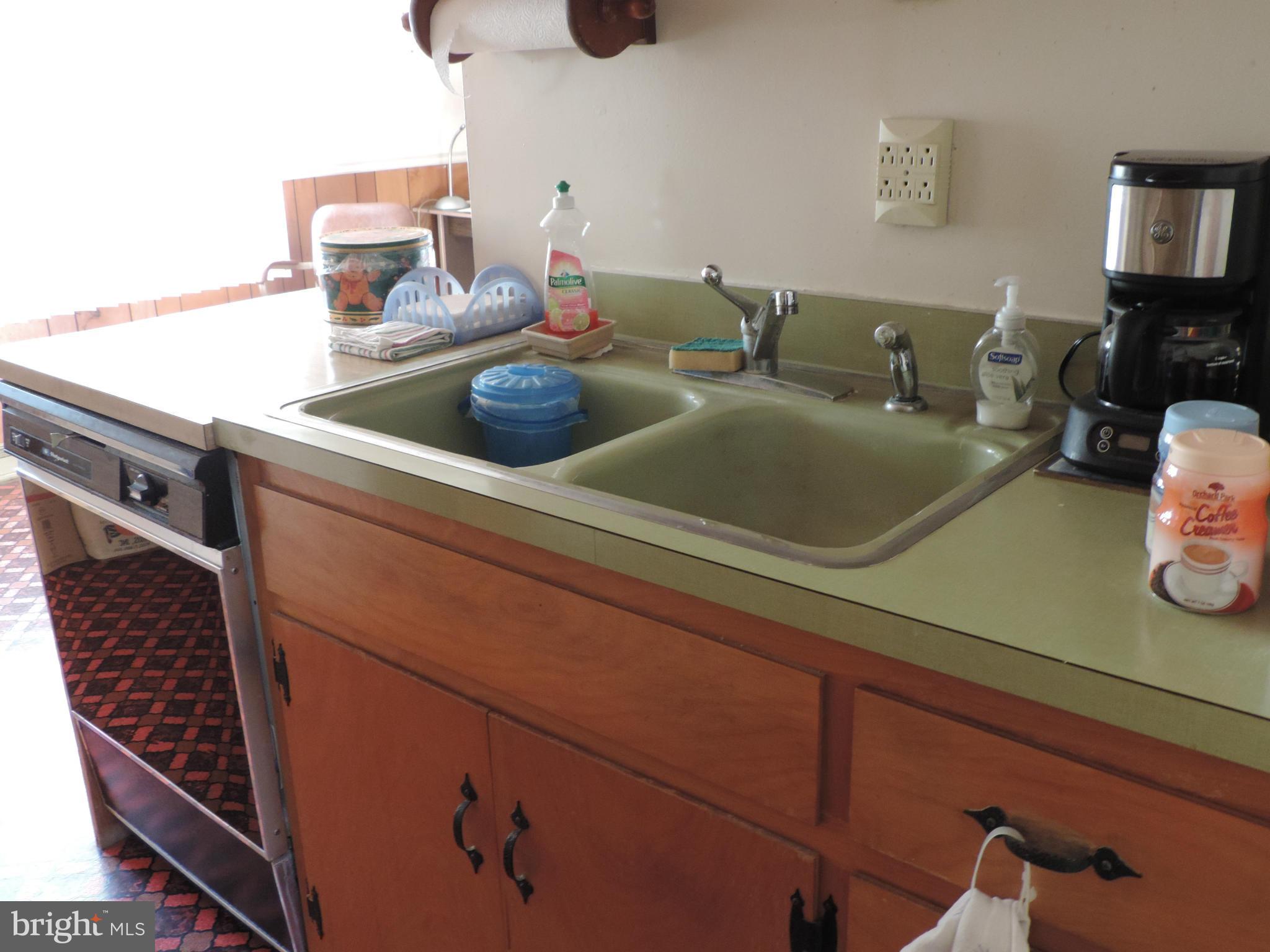 9215 Hawkins Creamery Road Gaithersburg, MD 20882 - Photo 5 of 23 a kitchen with a sink and a stove with wooden floor
