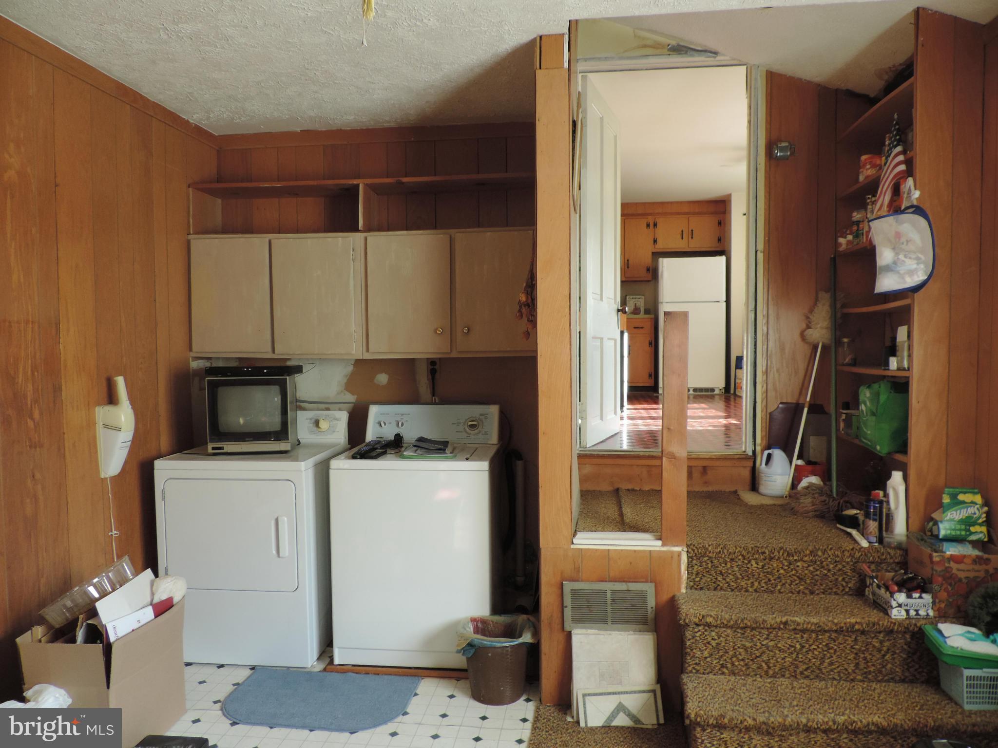 9215 Hawkins Creamery Road Gaithersburg, MD 20882 - Photo 7 of 23 a kitchen with a refrigerator and a stove
