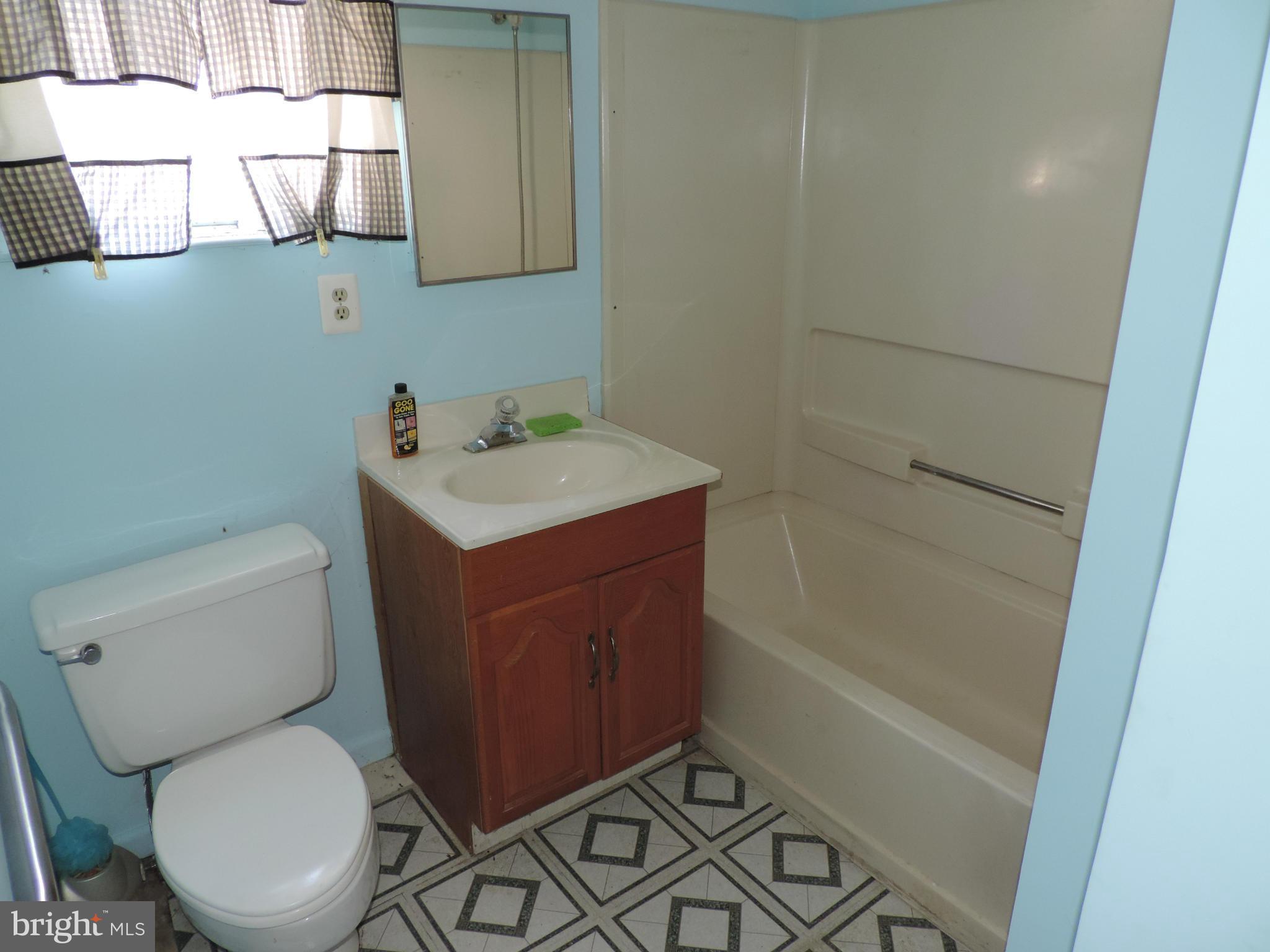 9215 Hawkins Creamery Road Gaithersburg, MD 20882 - Photo 10 of 23 a bathroom with a sink a toilet and shower
