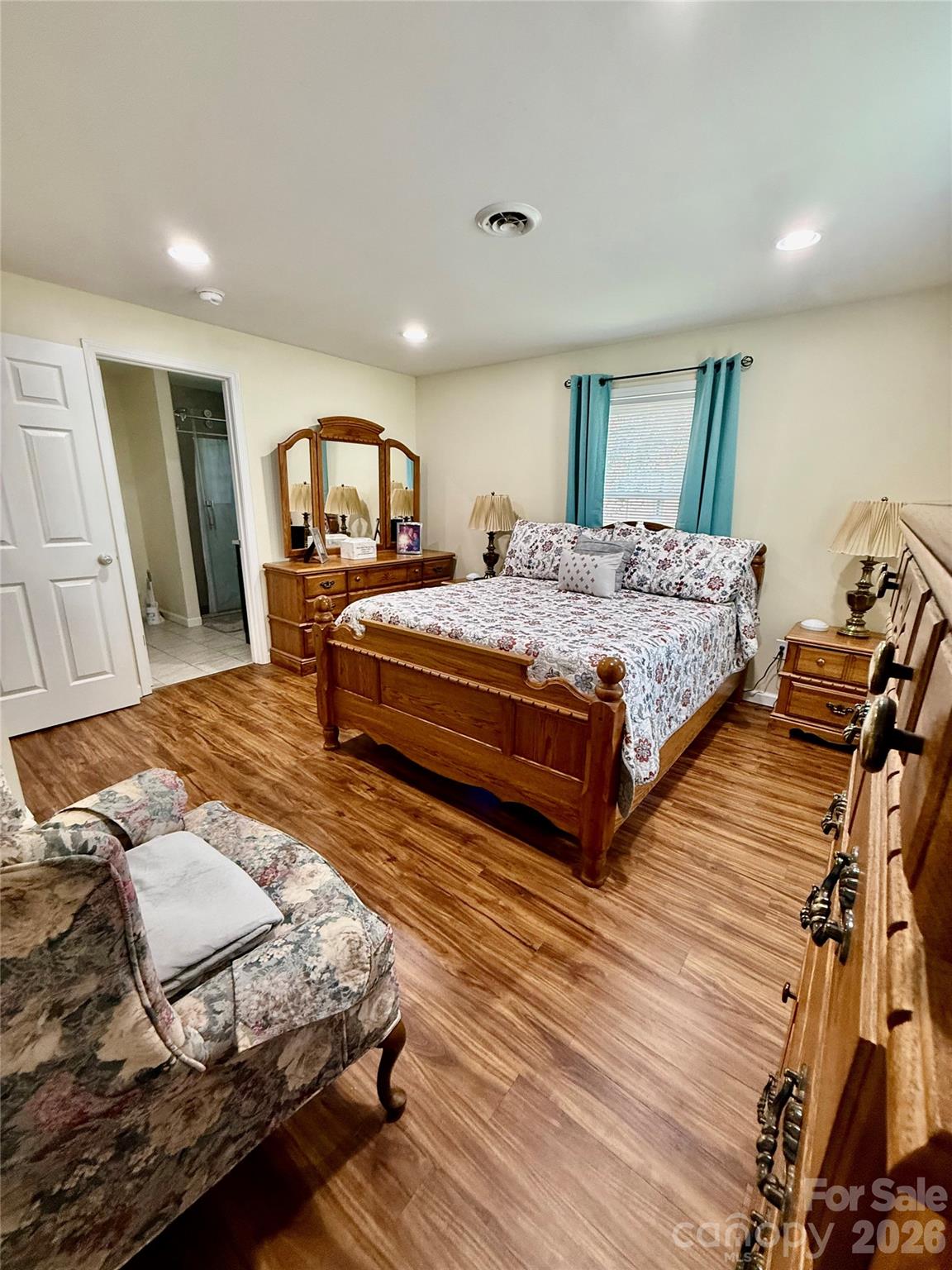 108 Scott Street Morganton, NC 28655 - Photo 11 of 21 a spacious bedroom with a bed and a table in it