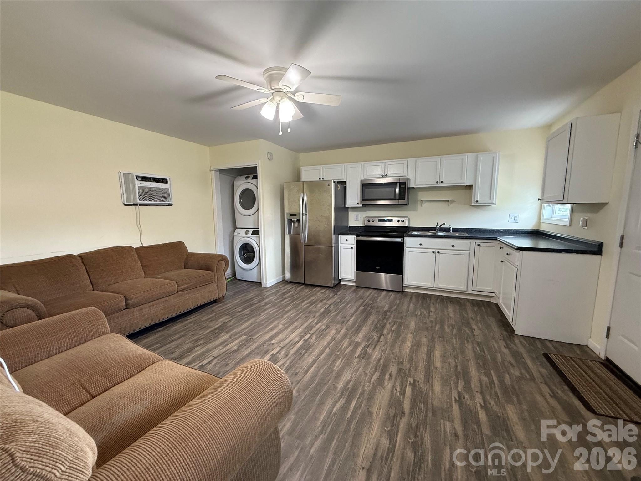 108 Scott Street Morganton, NC 28655 - Photo 19 of 21 a living room with stainless steel appliances granite countertop furniture and a flat screen tv