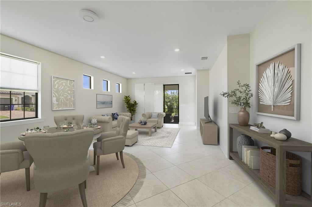 17301 Via Corsini Way Fort Myers, FL 33913 - Photo 3 of 17 a living room with furniture a large window and a table