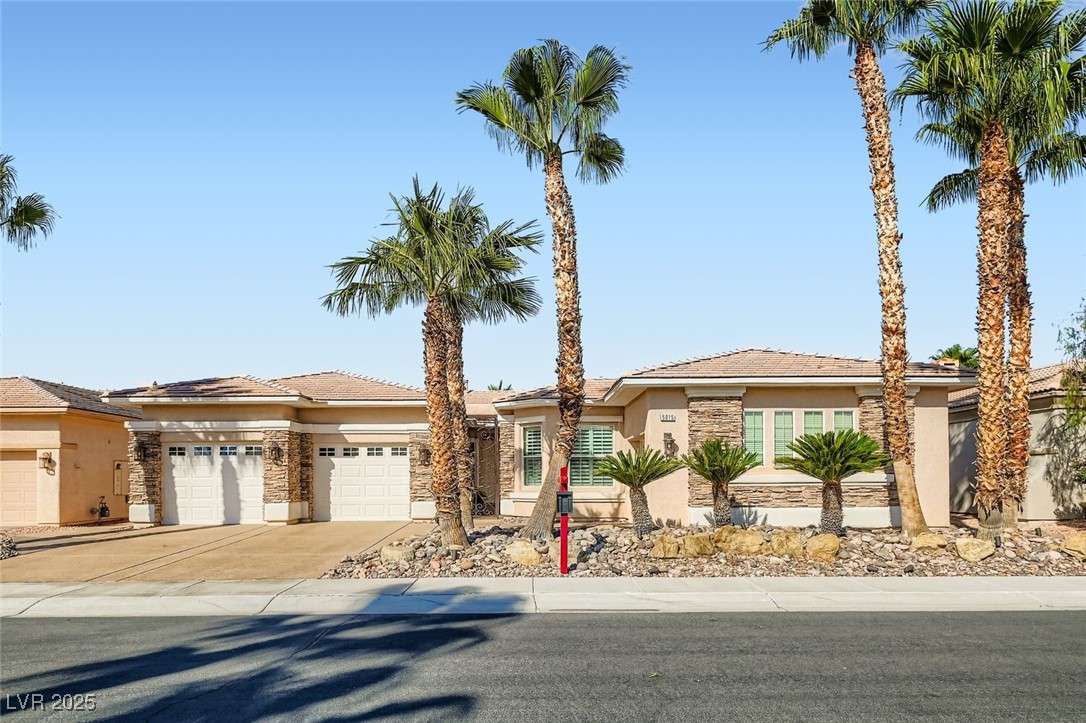 5015 Rivedro Street Las Vegas, NV 89135 - Photo 15 of 63 This beautifully crafted home features classic stucco siding, a tiled roof, and an attached 3 car garage with a welcoming driveway. Thoughtfully landscaped with Water-Smart principles, the front yard blends desert charm with eco-conscious efficiency—perfectly complementing the home’s timeless curb appeal.