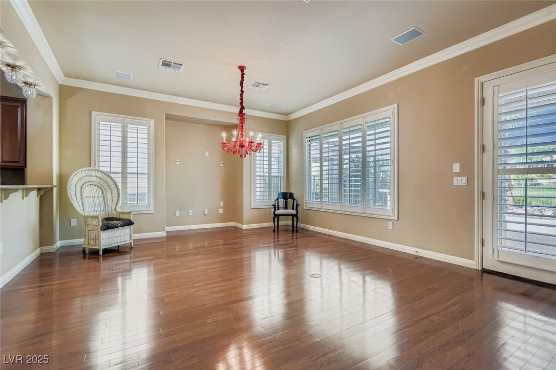 5015 Rivedro Street Las Vegas, NV 89135 - Photo 19 of 63 From the front entry, this open-concept layout reveals a versatile area ideal for formal dining in the foreground and a spacious family room beyond. A recessed niche at center stage offers the perfect spot for a built-in entertainment center—blending comfort, function, and architectural charm.