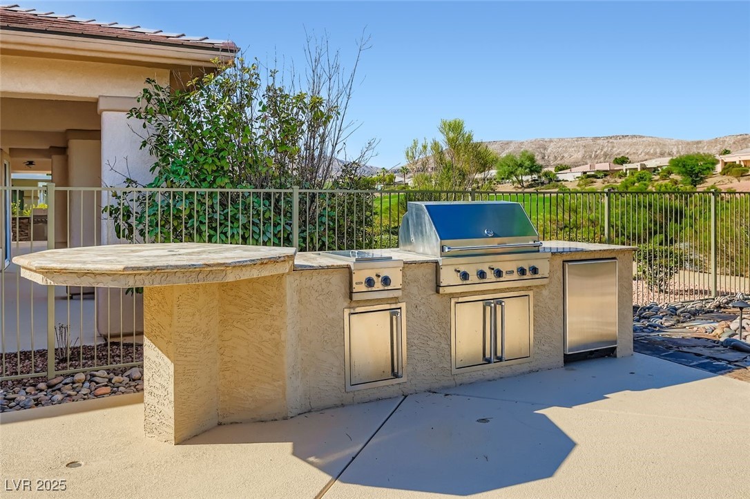 5015 Rivedro Street Las Vegas, NV 89135 - Photo 28 of 63 This rarely used outdoor kitchen has been completely rebuilt and is now primed for unforgettable barbeques. With refreshed finishes and ample prep space, it’s the perfect setting for grilling, gathering, and enjoying the best of outdoor living.