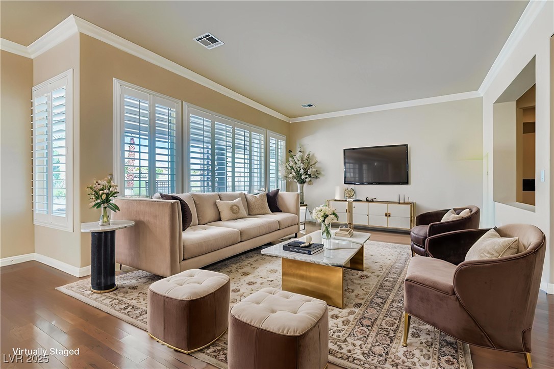 5015 Rivedro Street Las Vegas, NV 89135 - Photo 4 of 63 Virtual Image- This inviting living room features light wood-style flooring, elegant crown molding, and timeless plantation shutters. French doors open to a spacious patio, seamlessly blending indoor comfort with outdoor charm.