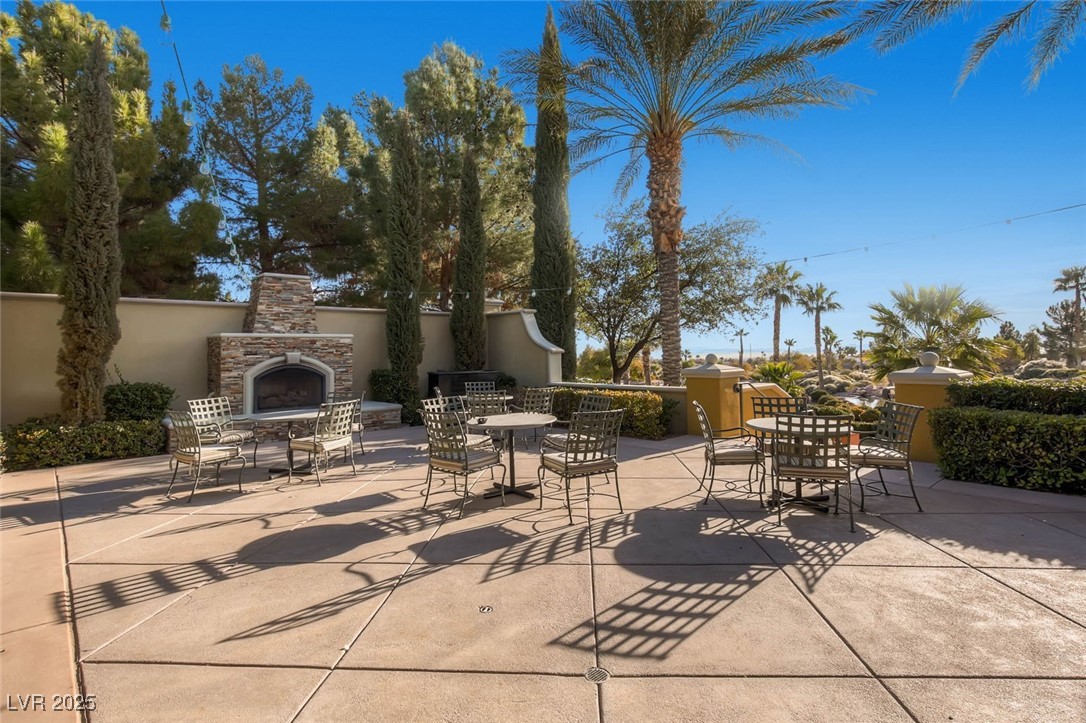 5015 Rivedro Street Las Vegas, NV 89135 - Photo 57 of 63 "Siena Bistro’s patio terrace — an inviting outdoor dining space complete with a charming stone fireplace and scenic surroundings."