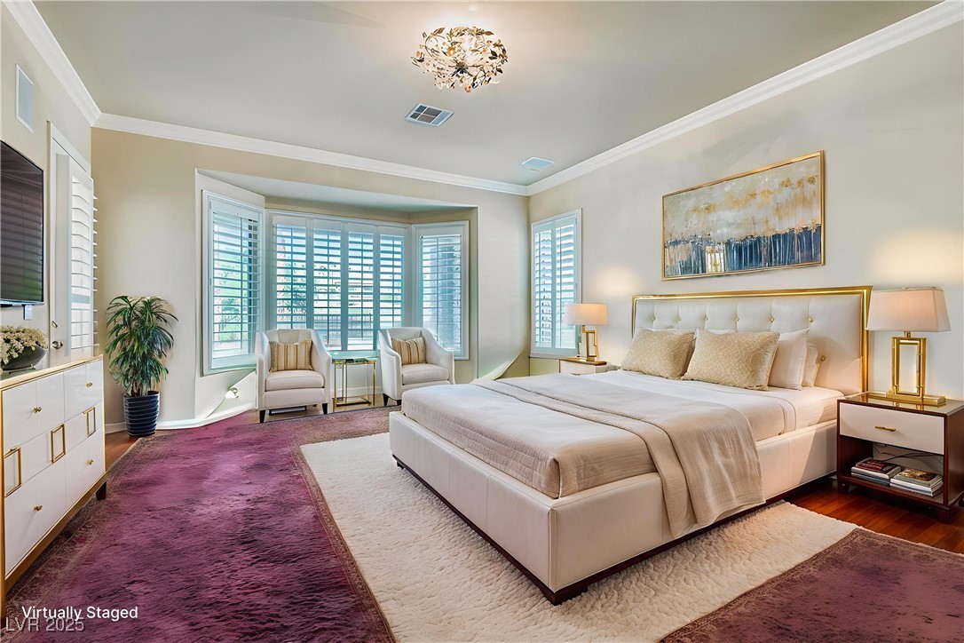 5015 Rivedro Street Las Vegas, NV 89135 - Photo 8 of 63 Virtually Staged- This spacious Primary Bedroom bedroom features elegant plantation shutters, a bay window that adds dimension and light, and direct access to the expansive patio. From here, enjoy breathtaking views of the golf course and surrounding mountains—an everyday escape into desert tranquility.