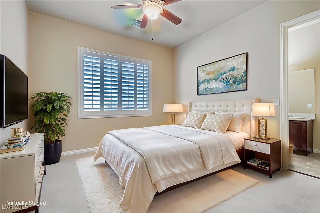 5015 Rivedro Street Las Vegas, NV 89135 - Photo 10 of 63 Virtually Staged- This well-appointed secondary bedroom features soft carpet flooring, elegant plantation shutters, and a private ensuite bathroom—offering guests or family members a serene retreat with elevated finishes.