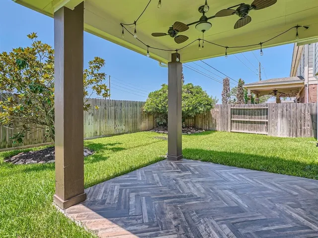 a view of a porch with a table and chairs under an umbrella