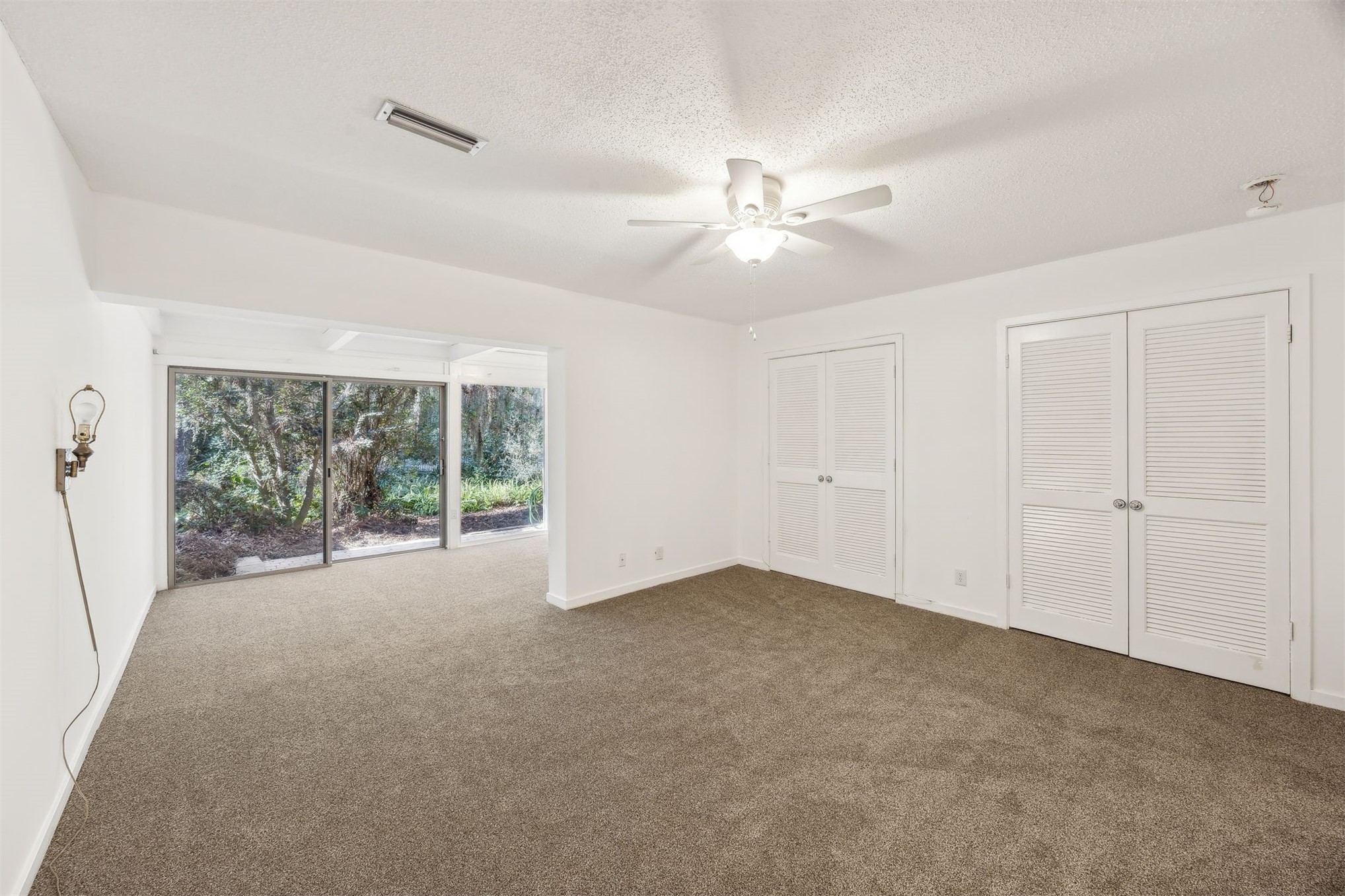 3207 Sea Marsh Road Fernandina Beach, FL 32034 - Photo 16 of 37 an empty room with windows and fan