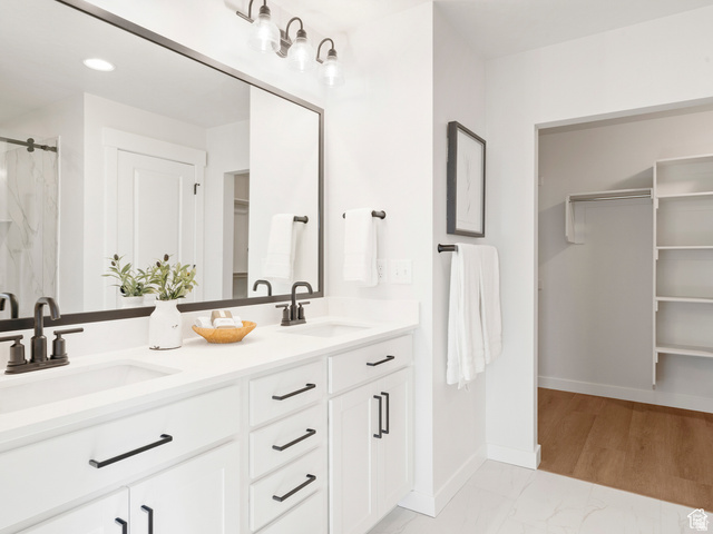 1711 West Canyon Rim Road North Lehi, UT 84048 - Photo 14 of 31 Dual sink vanity with white countertops, matte black fixtures, and a large framed mirror