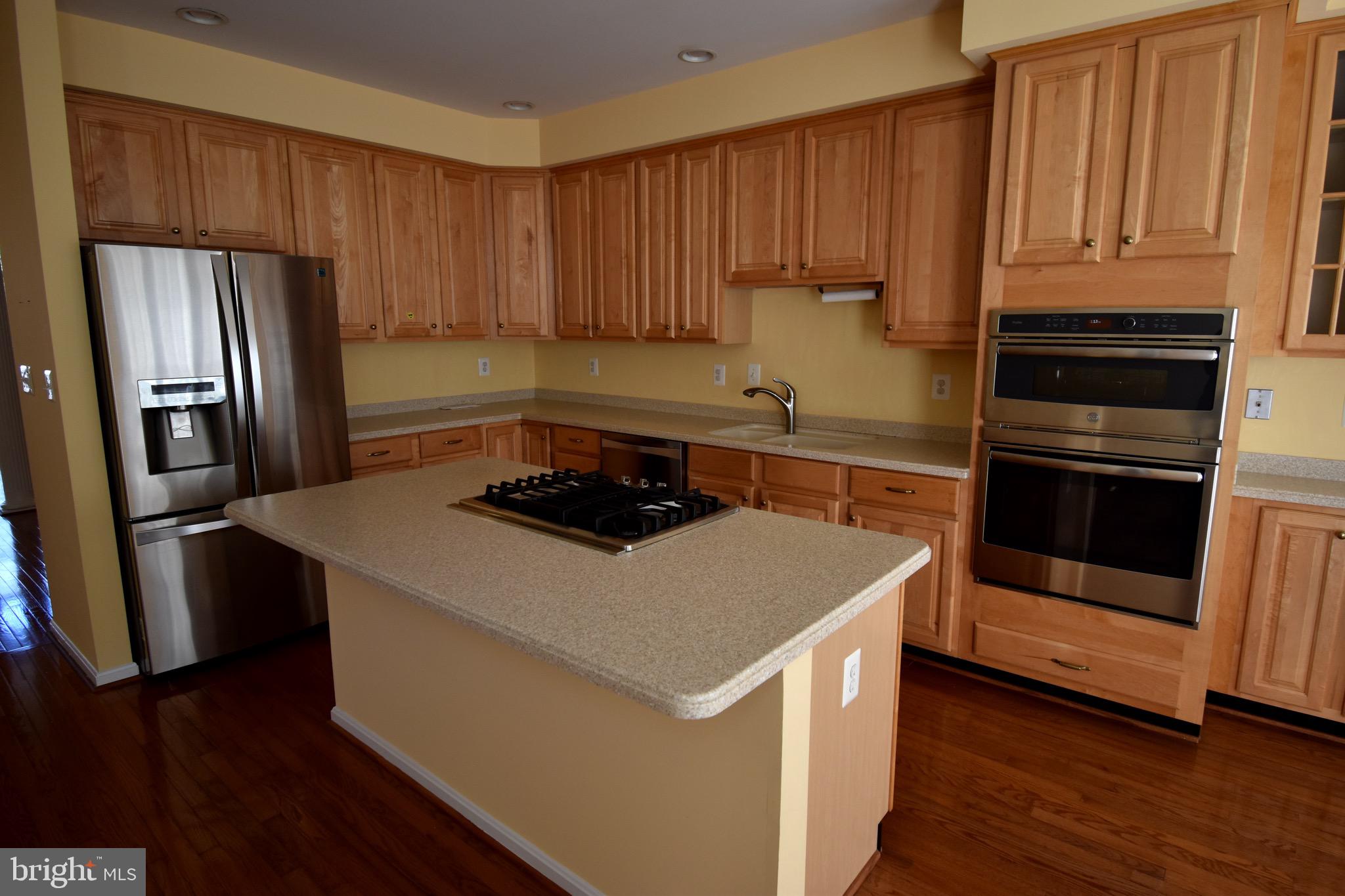 13571 Cedar Run Lane Herndon, VA 20171 - Photo 12 of 33 a kitchen with a sink stove and refrigerator