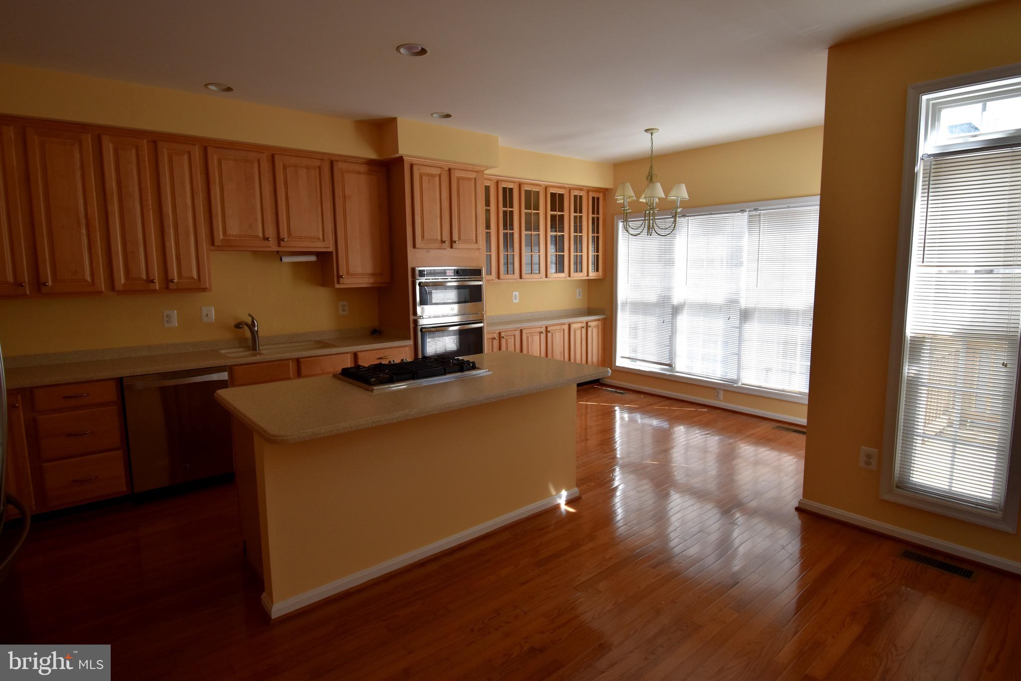 13571 Cedar Run Lane Herndon, VA 20171 - Photo 13 of 33 a kitchen with stainless steel appliances granite countertop a stove a sink and a refrigerator with wooden floor