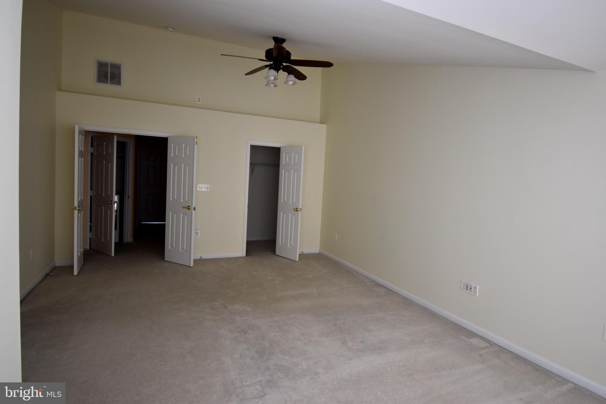 13571 Cedar Run Lane Herndon, VA 20171 - Photo 21 of 33 an empty room with a ceiling fan and carpet