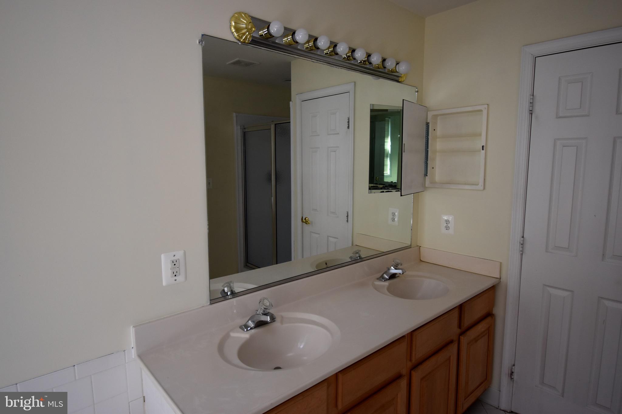 13571 Cedar Run Lane Herndon, VA 20171 - Photo 23 of 33 a bathroom with a sink and a mirror