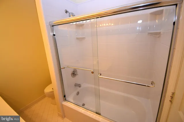 a bathroom with a glass shower door