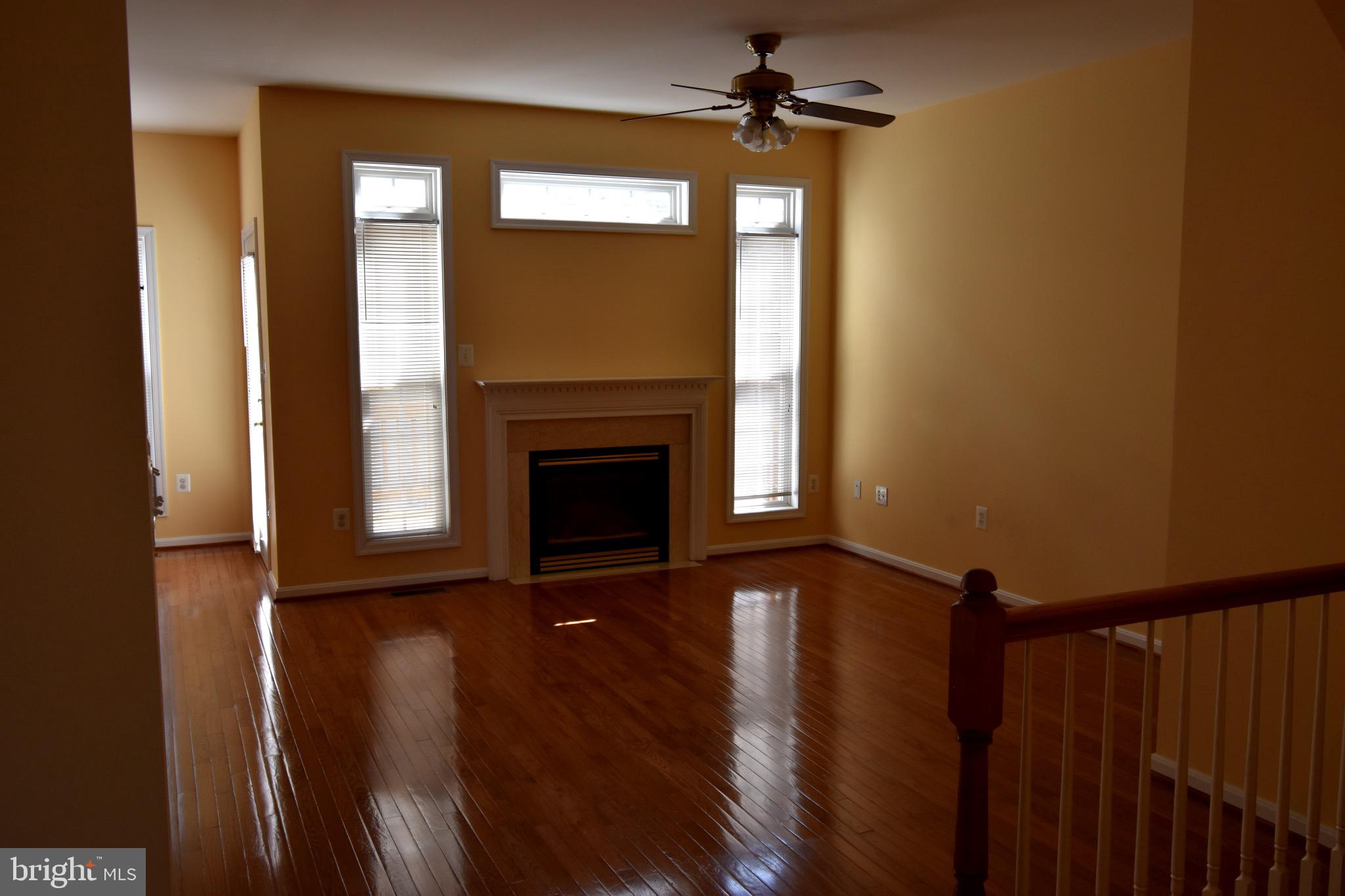 13571 Cedar Run Lane Herndon, VA 20171 - Photo 9 of 33 a view of an empty room with a fireplace and a window